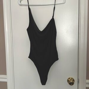 Asymmetrical thong style bodysuit.  New with tags.
